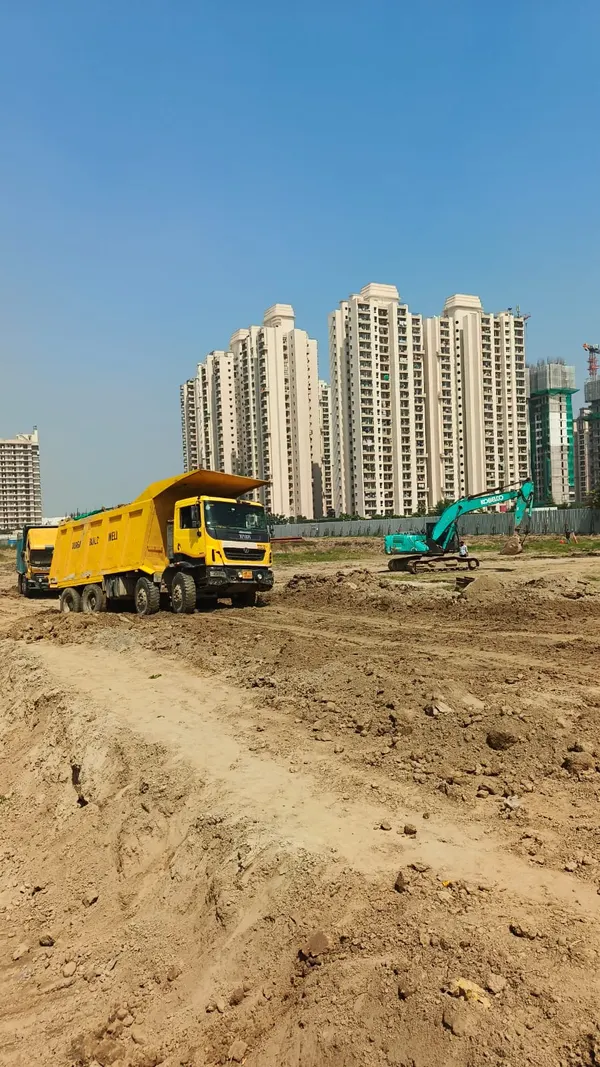 Tipper and excavator during bulk excavation